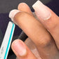 Student filing an acrylic nail on an in person acrylic course